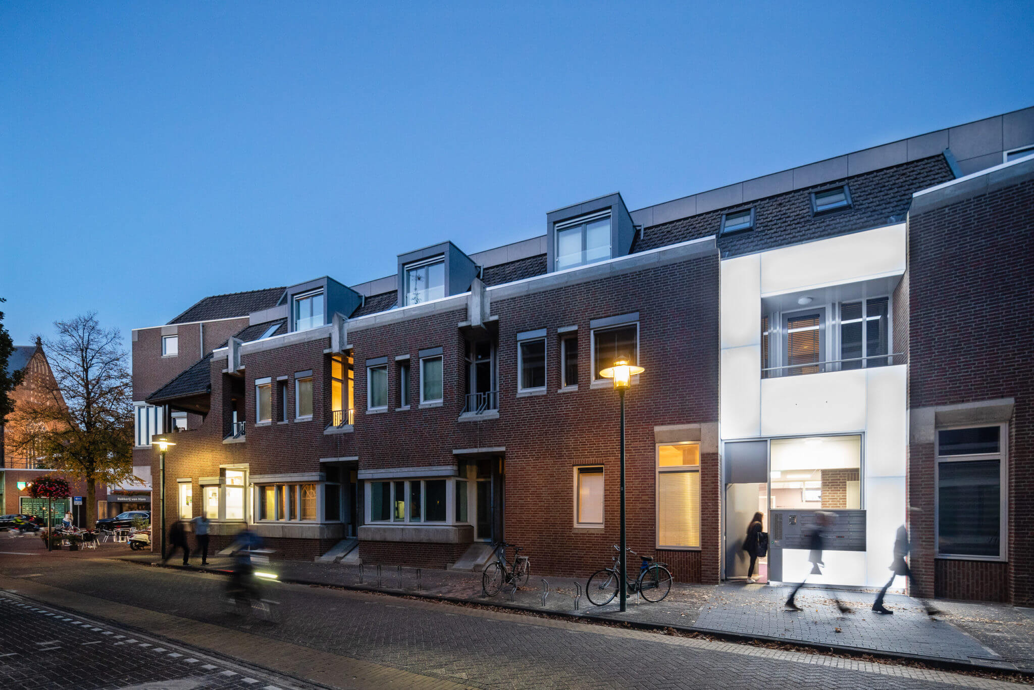 wonen appartementen Deurne Rabobank transformatie hergebruik sociaal Van den Acker Bossche School soberheid balkons lichtbaken baksteen beton betonbanden Struyken modern monument